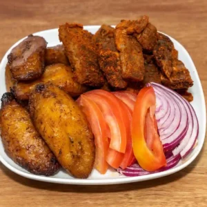 Fried plantain with beef suya, fresh tomatoes and onion