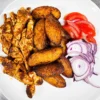 Chicken suya and fried plantain, fresh tomatoes and onion