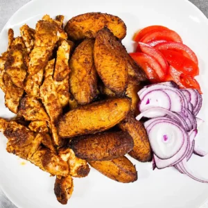 Chicken suya and fried plantain, fresh tomatoes and onion